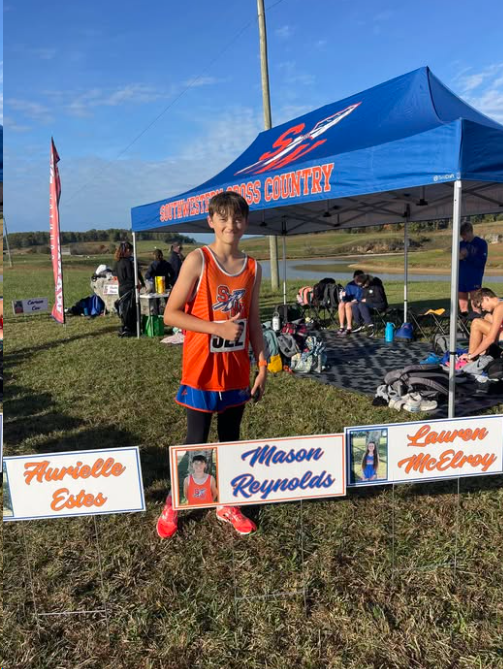 Cross country runner with the lake in the background at Cave Lake Event Park